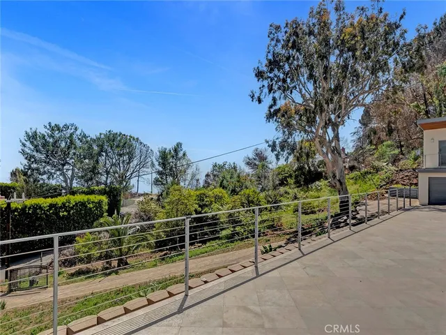 a large living room with stainless steel appliances kitchen island granite countertop a table chairs and a view of living room
