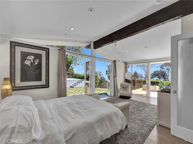 a spacious bedroom with a bed and a couch