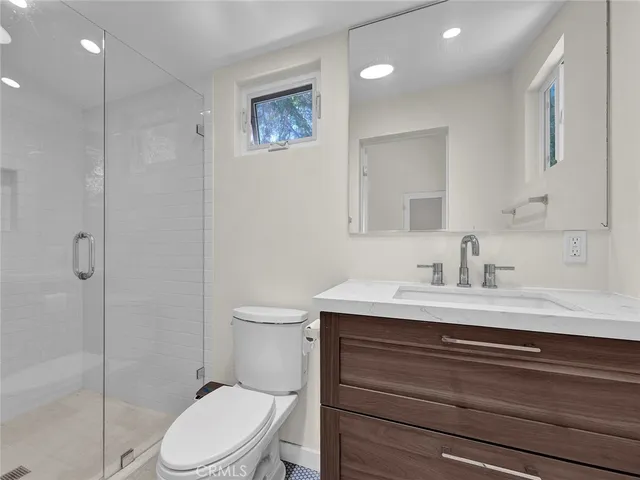 a kitchen with white cabinets and sink