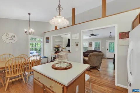 a view of a dining room with furniture a chandelier and wooden floor