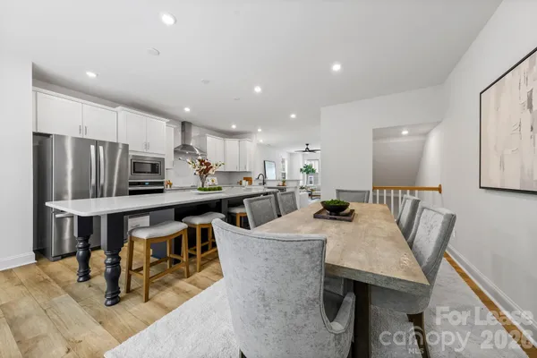 a large kitchen with a table and chairs