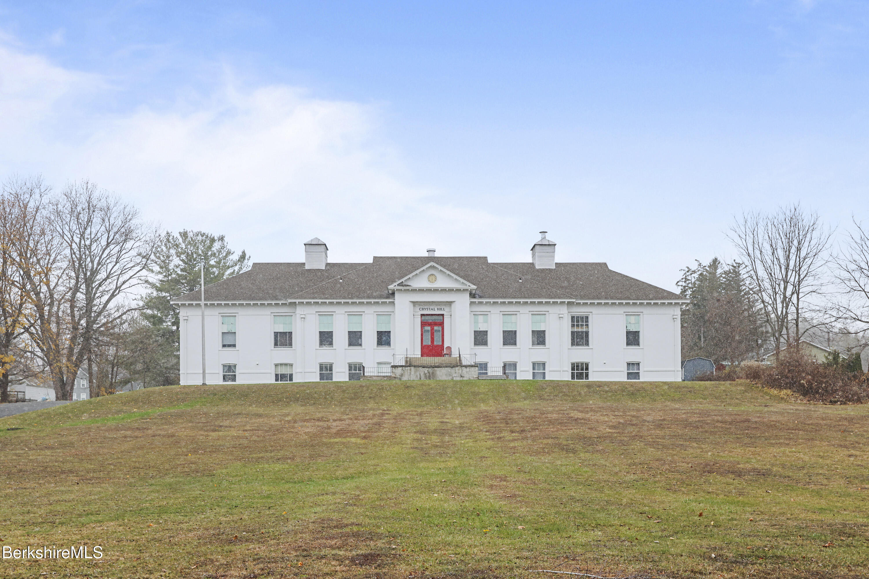 55 Crystal Street, Unit 8 Lenox, MA 01242 - Photo 1 of 12 a large building with a large garden in front of it