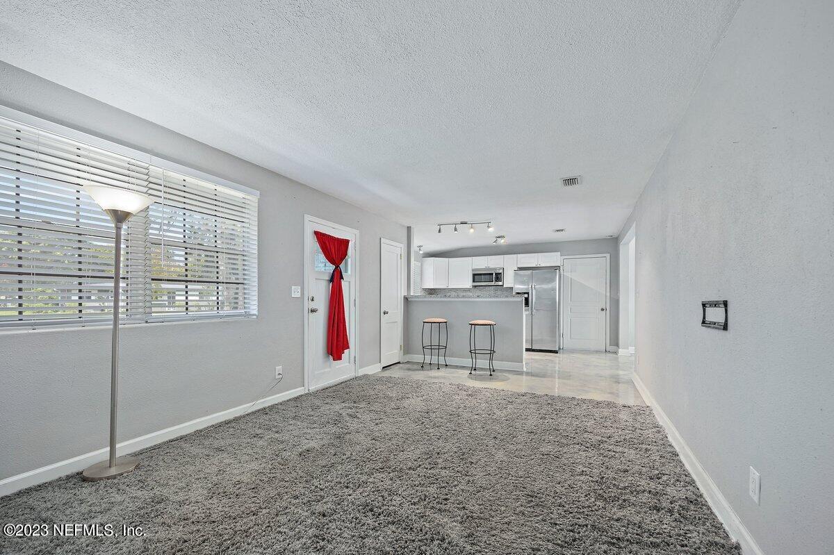 949 Ibis Road Jacksonville, FL 32216 - Photo 3 of 15 Living Room to Kitchen (1)