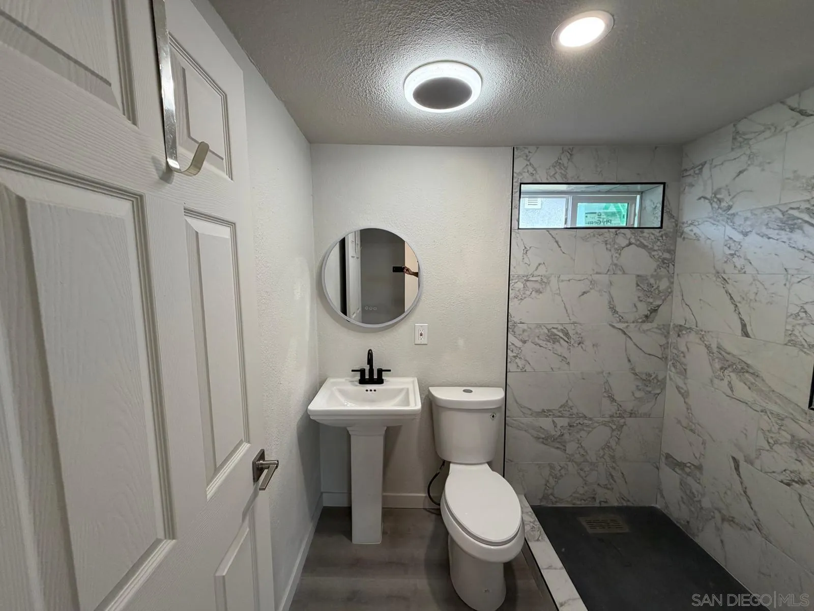 2959 Ridgeway Drive National City, CA 91950 - Photo 7 of 12 a bathroom with a toilet sink and mirror