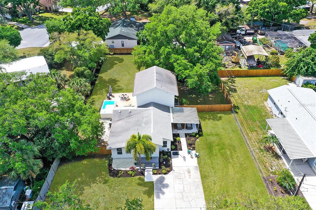 an aerial view of a house with outdoor space pool seating area and yard