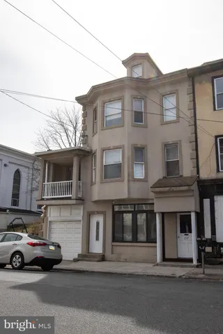 a couple of cars parked in front of a house
