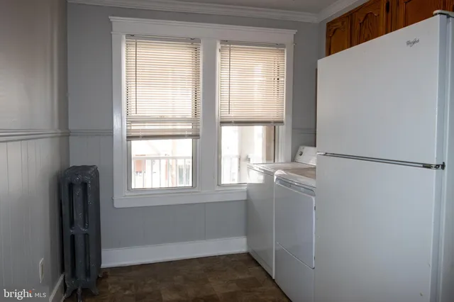 a room with window and refrigerator