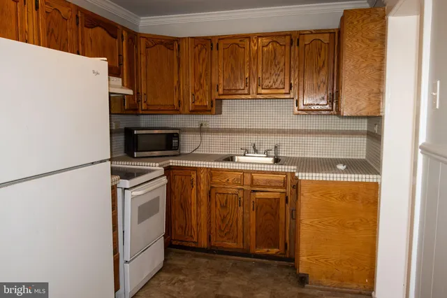 a kitchen with stainless steel appliances granite countertop a refrigerator sink and cabinets