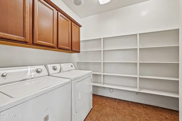 a kitchen with kitchen island wooden cabinets a refrigerator stove top oven and sink