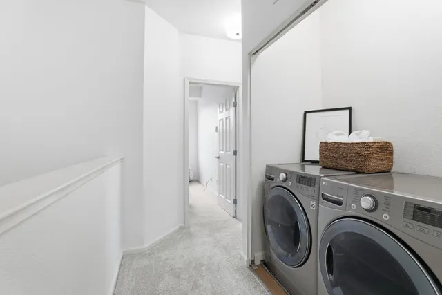 a living room with furniture and a washer dryer