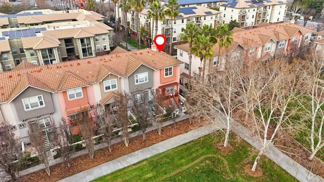 a aerial view of multi story residential apartment building with yard