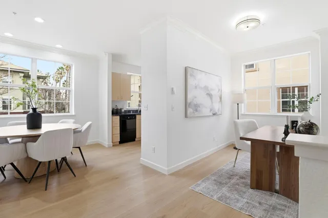 a dining room with wooden floor and furniture