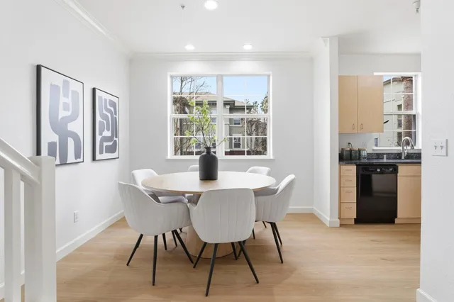a view of a dining room with furniture window and wooden floor