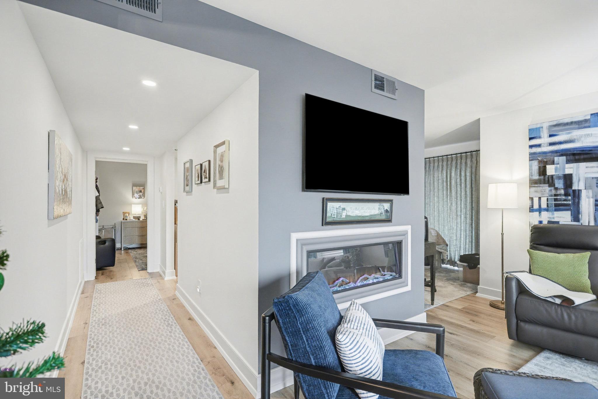 1000 Country Club Road, Unit A13 York, PA 17403 - Photo 3 of 23 a living room with furniture a flat screen tv and a fireplace