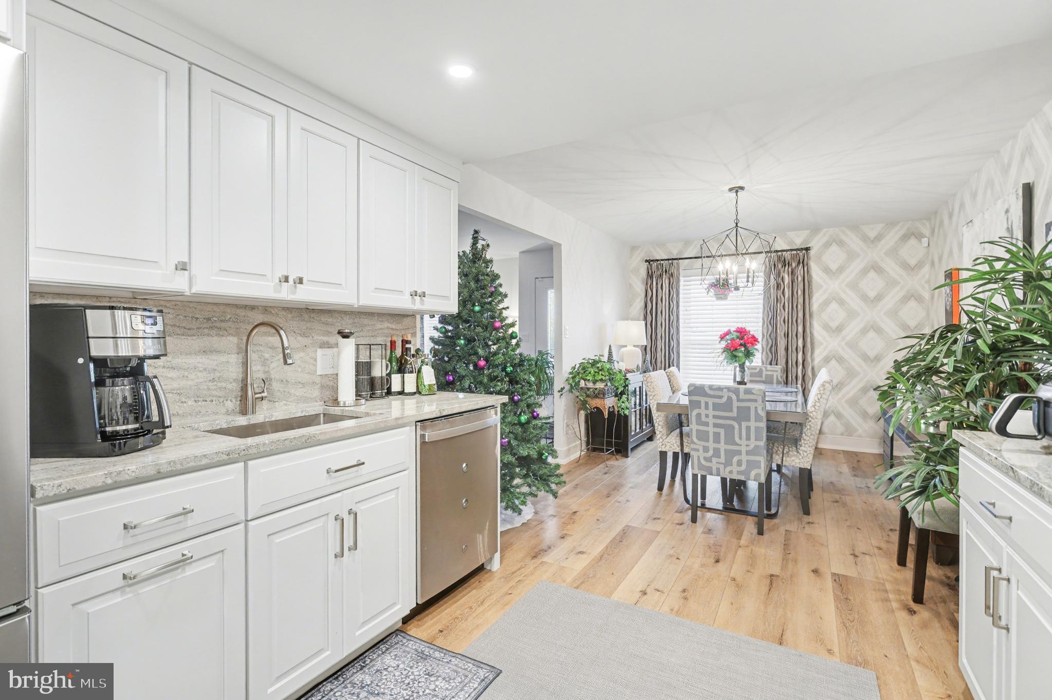 1000 Country Club Road, Unit A13 York, PA 17403 - Photo 7 of 23 a kitchen with granite countertop sink window and white cabinets