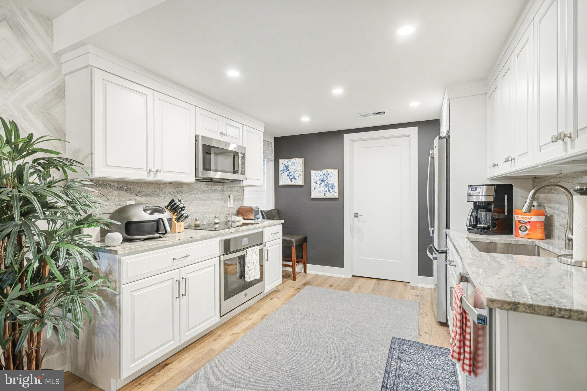 1000 Country Club Road, Unit A13 York, PA 17403 - Photo 8 of 23 a kitchen with stainless steel appliances granite countertop a stove a sink and a refrigerator