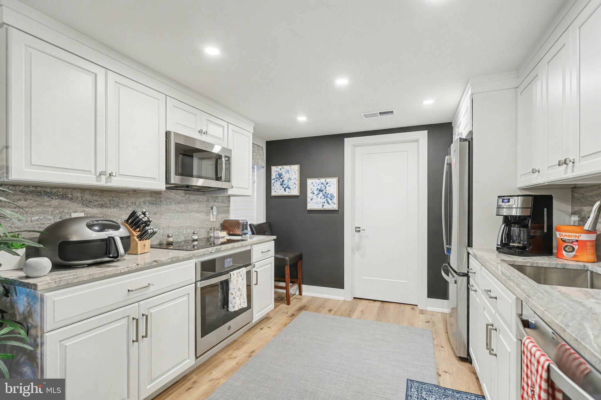 1000 Country Club Road, Unit A13 York, PA 17403 - Photo 9 of 23 a kitchen with stainless steel appliances granite countertop a stove a sink and a refrigerator
