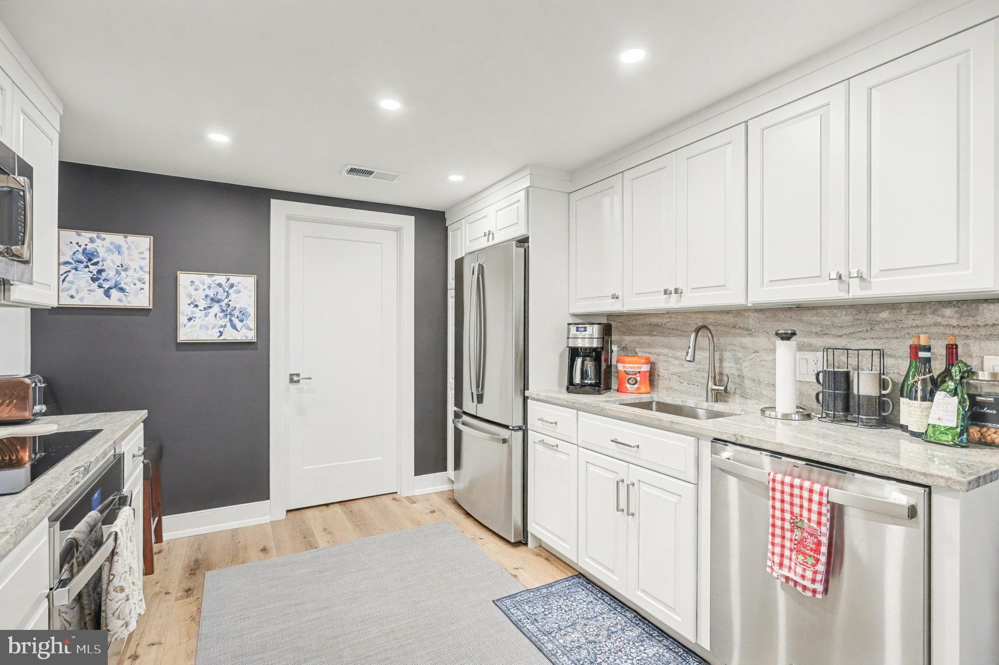 1000 Country Club Road, Unit A13 York, PA 17403 - Photo 10 of 23 a kitchen with stainless steel appliances granite countertop a refrigerator sink and white cabinets