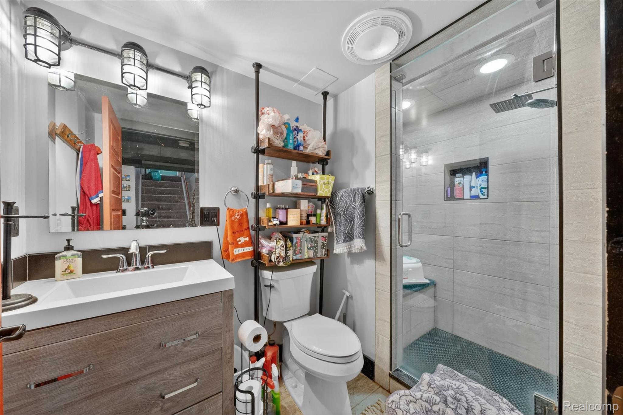 259 Sisson Street Romeo, MI 48065 - Photo 19 of 37 Bathroom with vanity, a stall shower, and light tile patterned floors