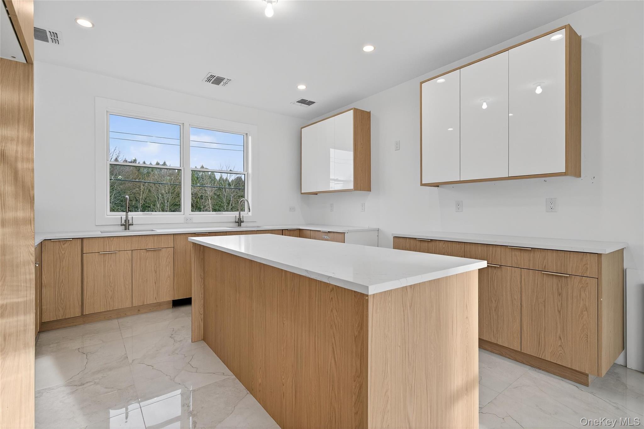 14 East Dillon Road Monticello, NY 12701 - Photo 11 of 50 Kitchen with light marble finish flooring, recessed lighting, white cabinetry, a kitchen island, and modern cabinets
