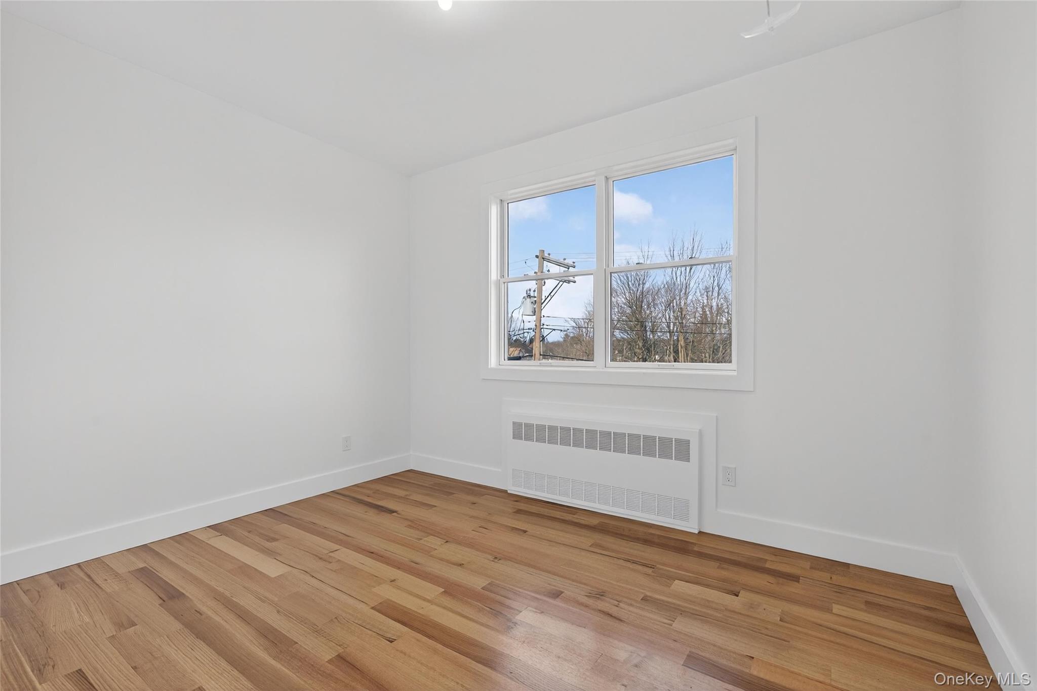 14 East Dillon Road Monticello, NY 12701 - Photo 32 of 50 a view of empty room with wooden floor and fan