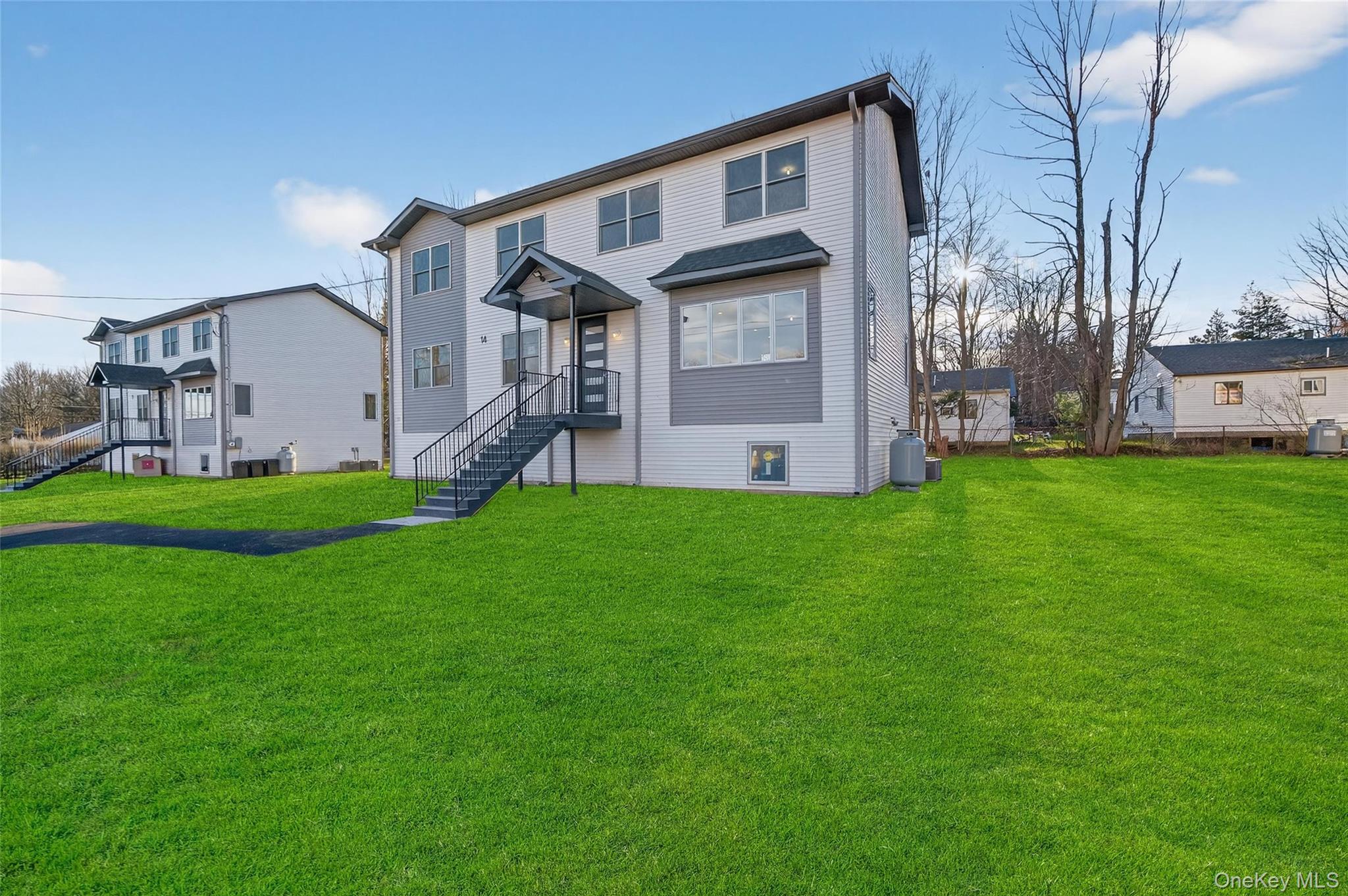 14 East Dillon Road Monticello, NY 12701 - Photo 5 of 50 Rear view of property featuring a lawn
