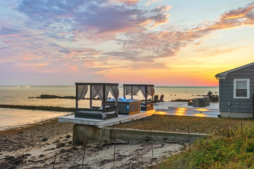 10 Silver Shell Beach Drive Fairhaven, MA 02719 - Photo 1 of 41 a view of a lake with a terrace