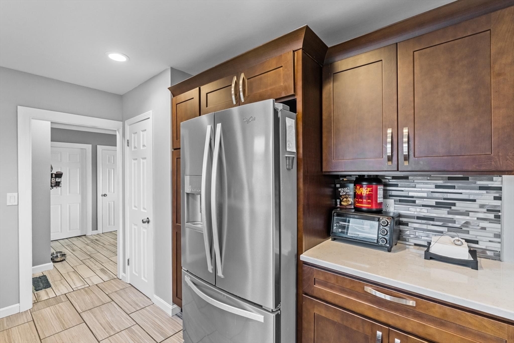 10 Silver Shell Beach Drive Fairhaven, MA 02719 - Photo 11 of 41 a kitchen with stainless steel appliances a refrigerator and a stove top oven