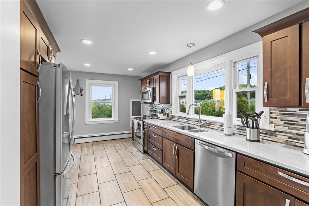 10 Silver Shell Beach Drive Fairhaven, MA 02719 - Photo 16 of 41 a kitchen with a sink stove and cabinets