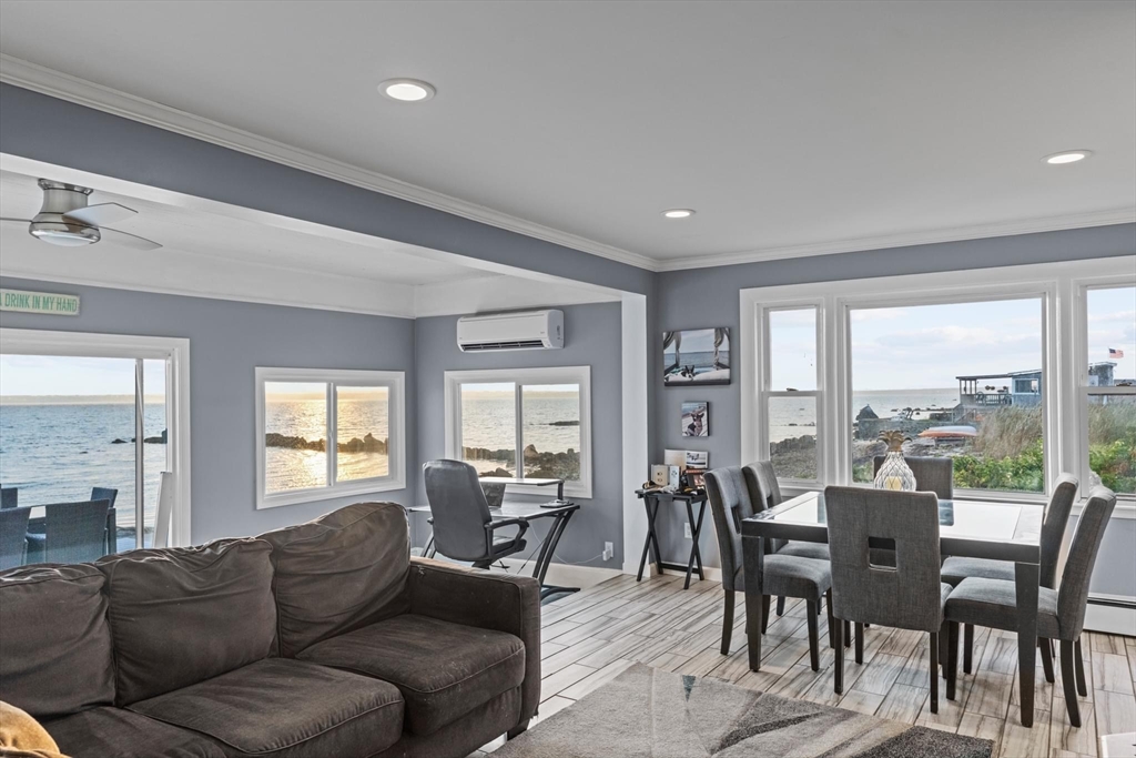 10 Silver Shell Beach Drive Fairhaven, MA 02719 - Photo 17 of 41 a living room with furniture wooden floor and a floor to ceiling window