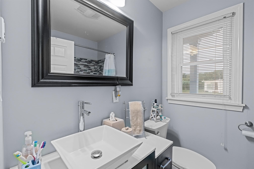 10 Silver Shell Beach Drive Fairhaven, MA 02719 - Photo 21 of 41 a bathroom with a toilet sink and mirror