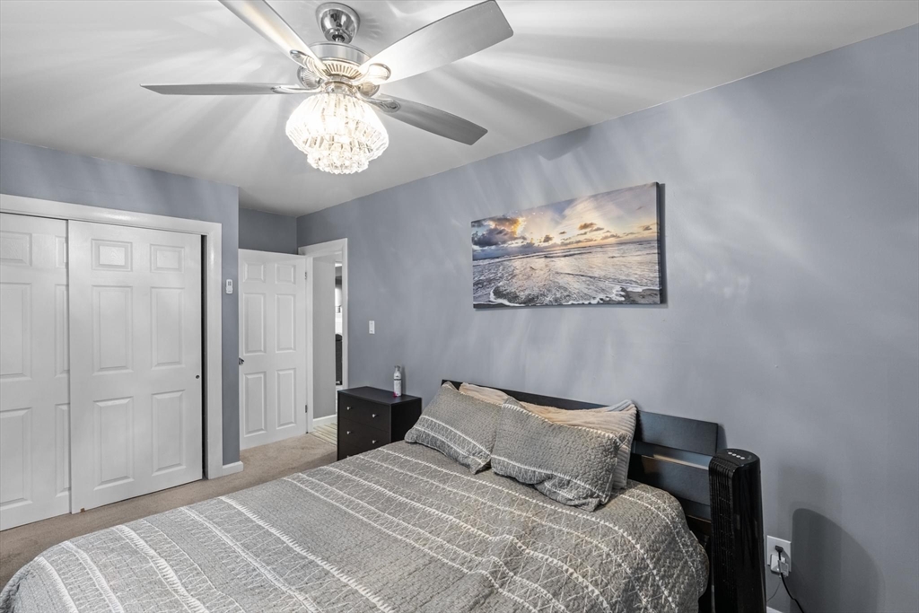 10 Silver Shell Beach Drive Fairhaven, MA 02719 - Photo 25 of 41 a bedroom with a bed and a chandelier