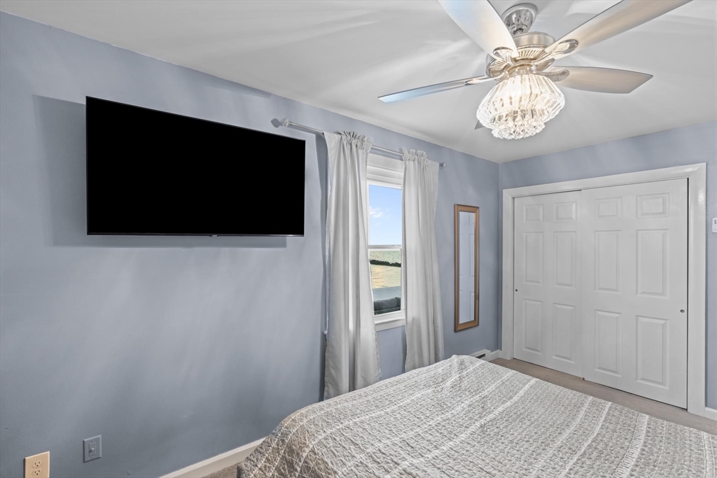 10 Silver Shell Beach Drive Fairhaven, MA 02719 - Photo 30 of 41 a bedroom with a bed and a flat tv screen on dresser