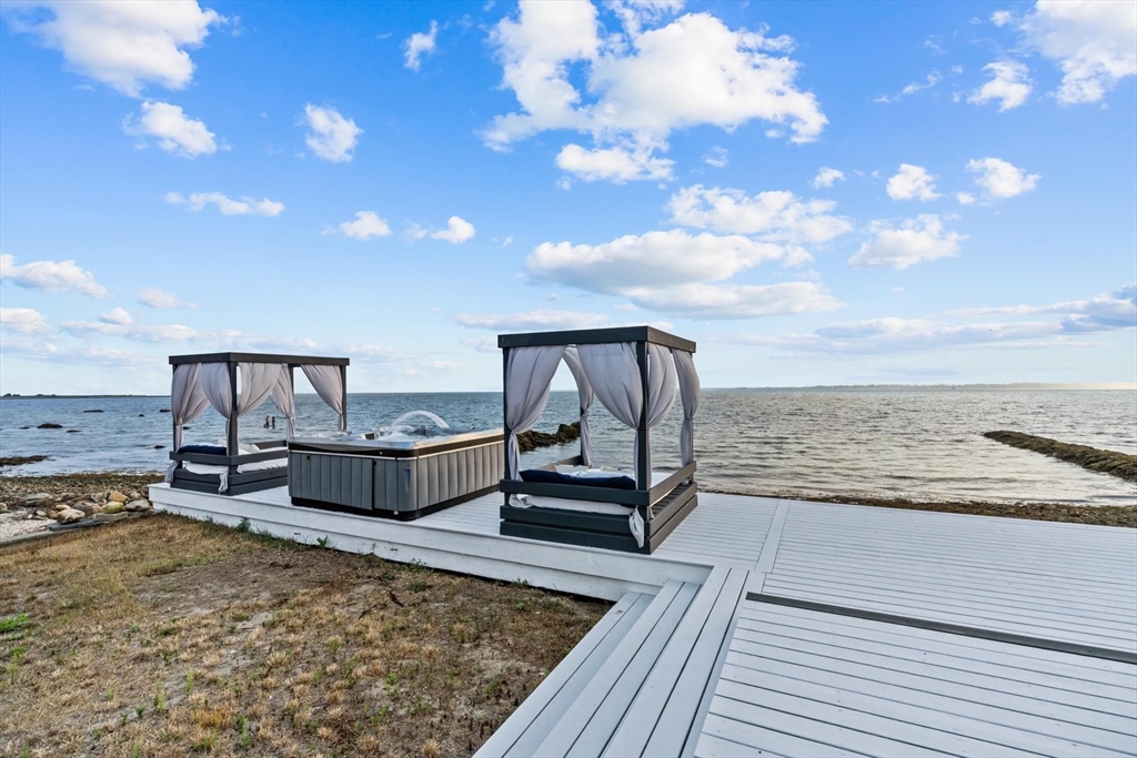 10 Silver Shell Beach Drive Fairhaven, MA 02719 - Photo 5 of 41 a view of a terrace with wooden floor and fence