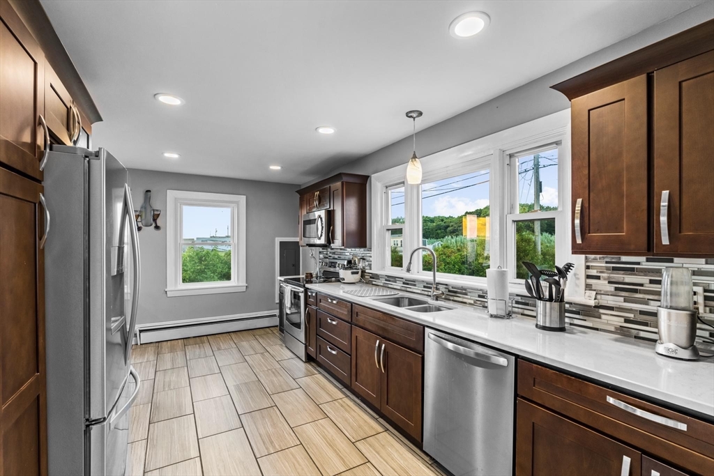 10 Silver Shell Beach Drive Fairhaven, MA 02719 - Photo 10 of 41 a kitchen with stainless steel appliances a sink stove and a refrigerator