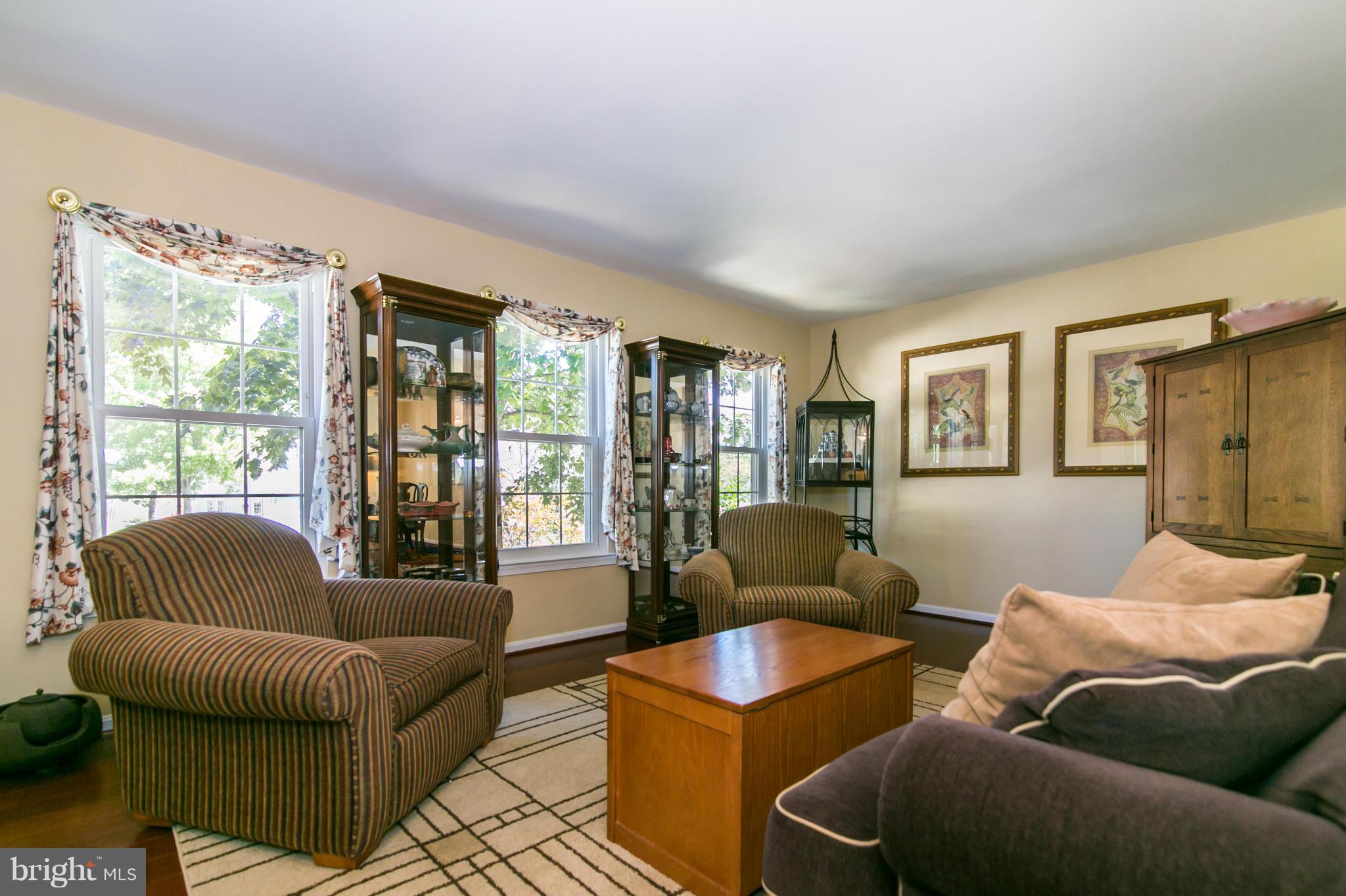 402 Spring Ridge Court Sterling, VA 20164 - Photo 4 of 30 The living room has three large windows.