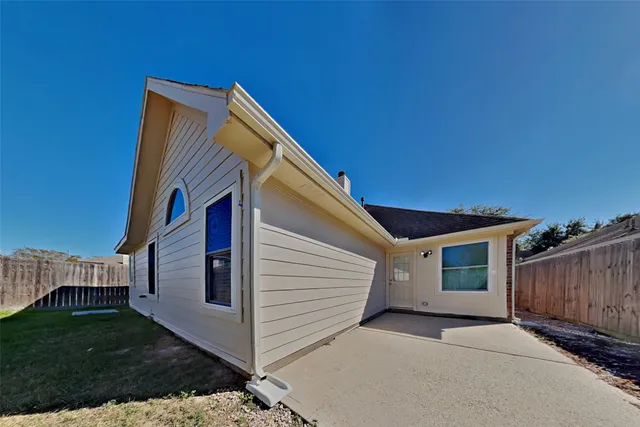 a view of house with backyard and deck