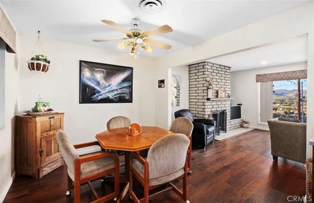 a dining room with furniture a window and wooden floor