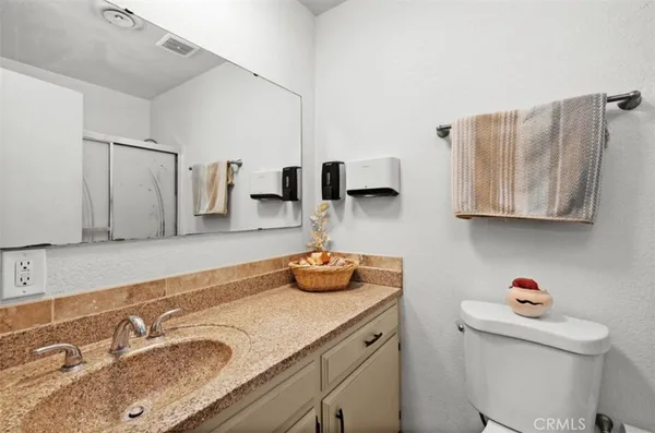 a bathroom with a sink double vanity and mirror