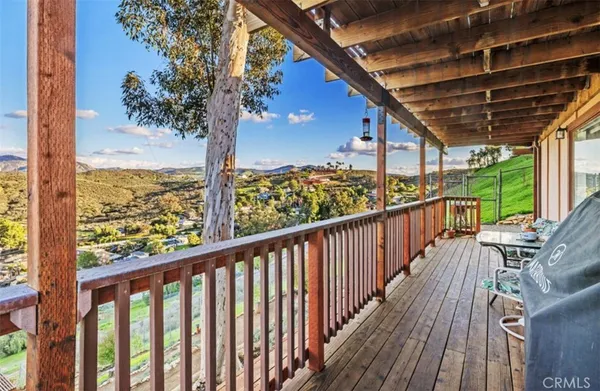 a view of a balcony with wooden floor