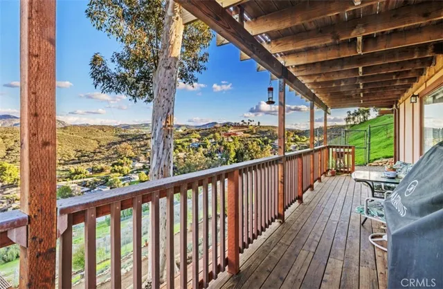a view of a balcony with wooden floor