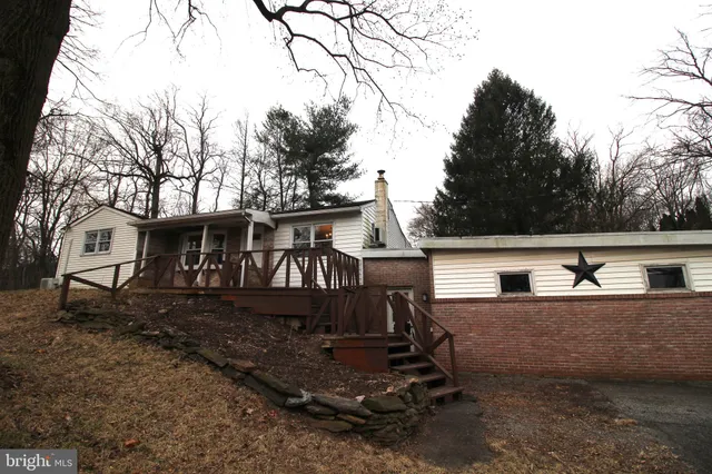 a view of a yard with wooden fence