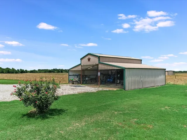 a view of a house with a yard and a garden