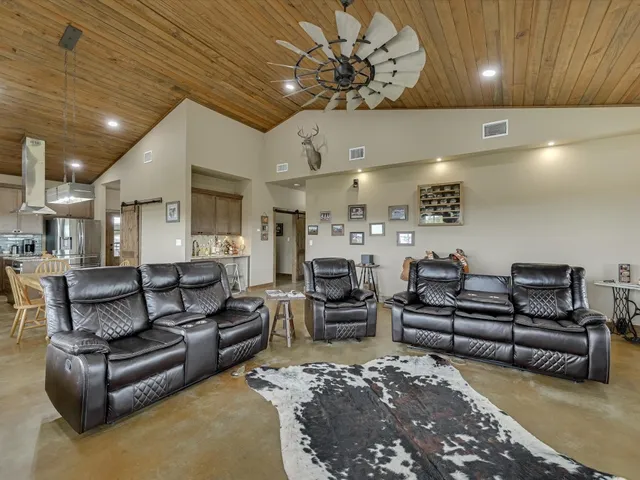 a living room with furniture and a chandelier