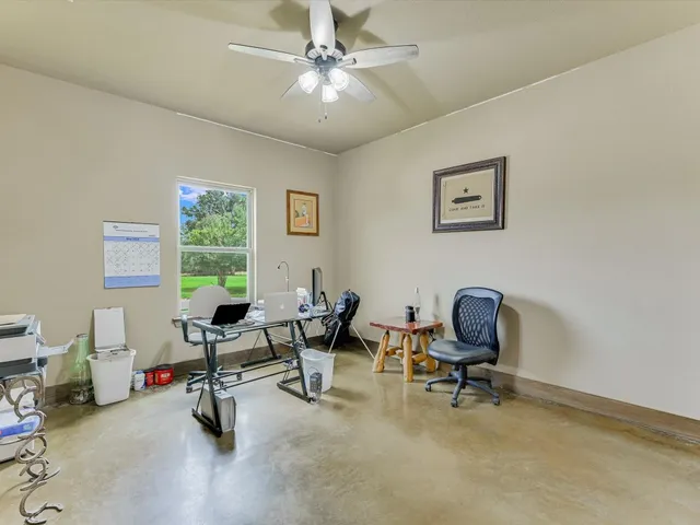 a en suite bathroom with a granite countertop sink and a mirror