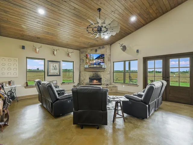 a living room with furniture ceiling fan and a rug