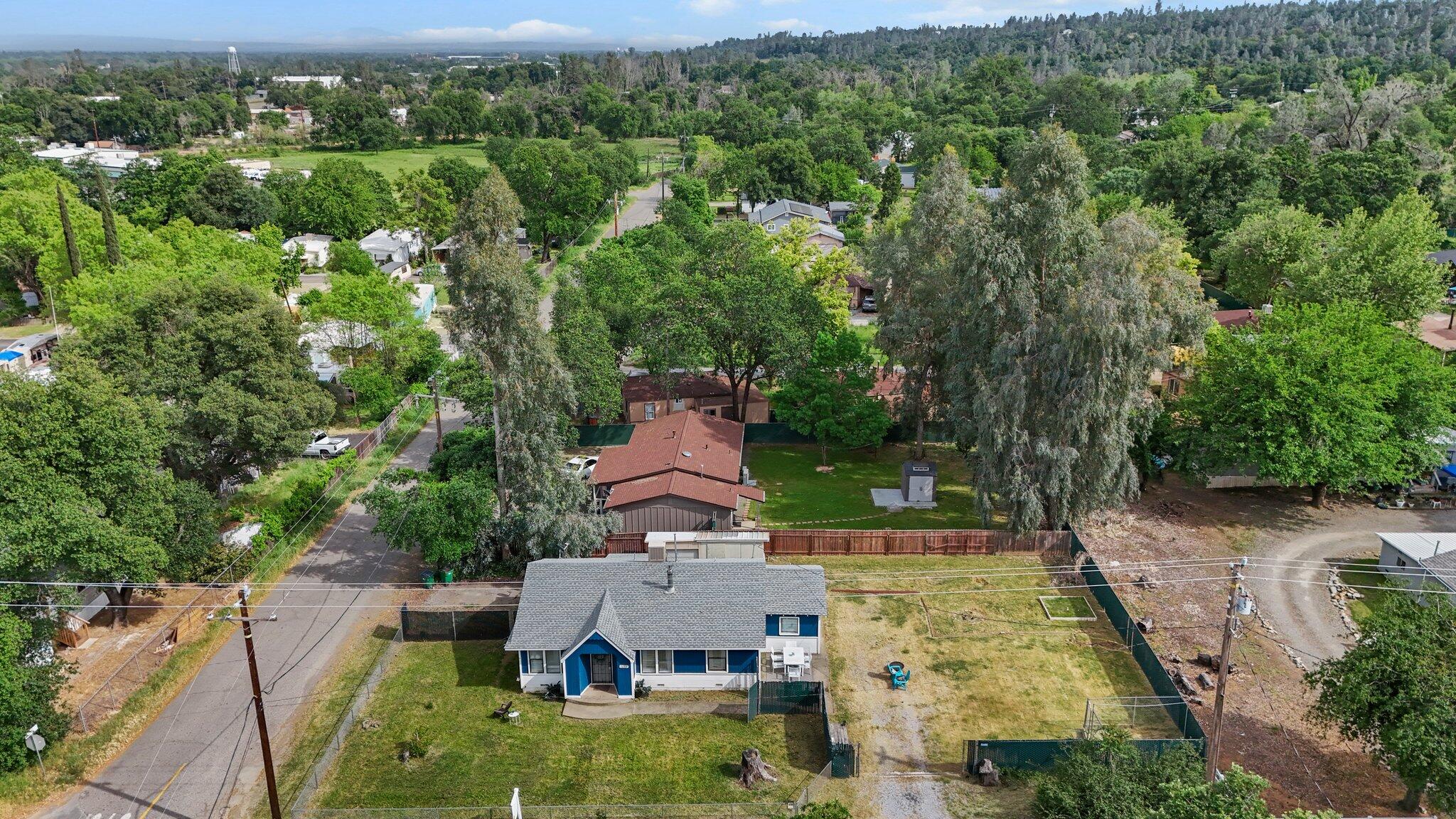 an aerial view of a house with a yard