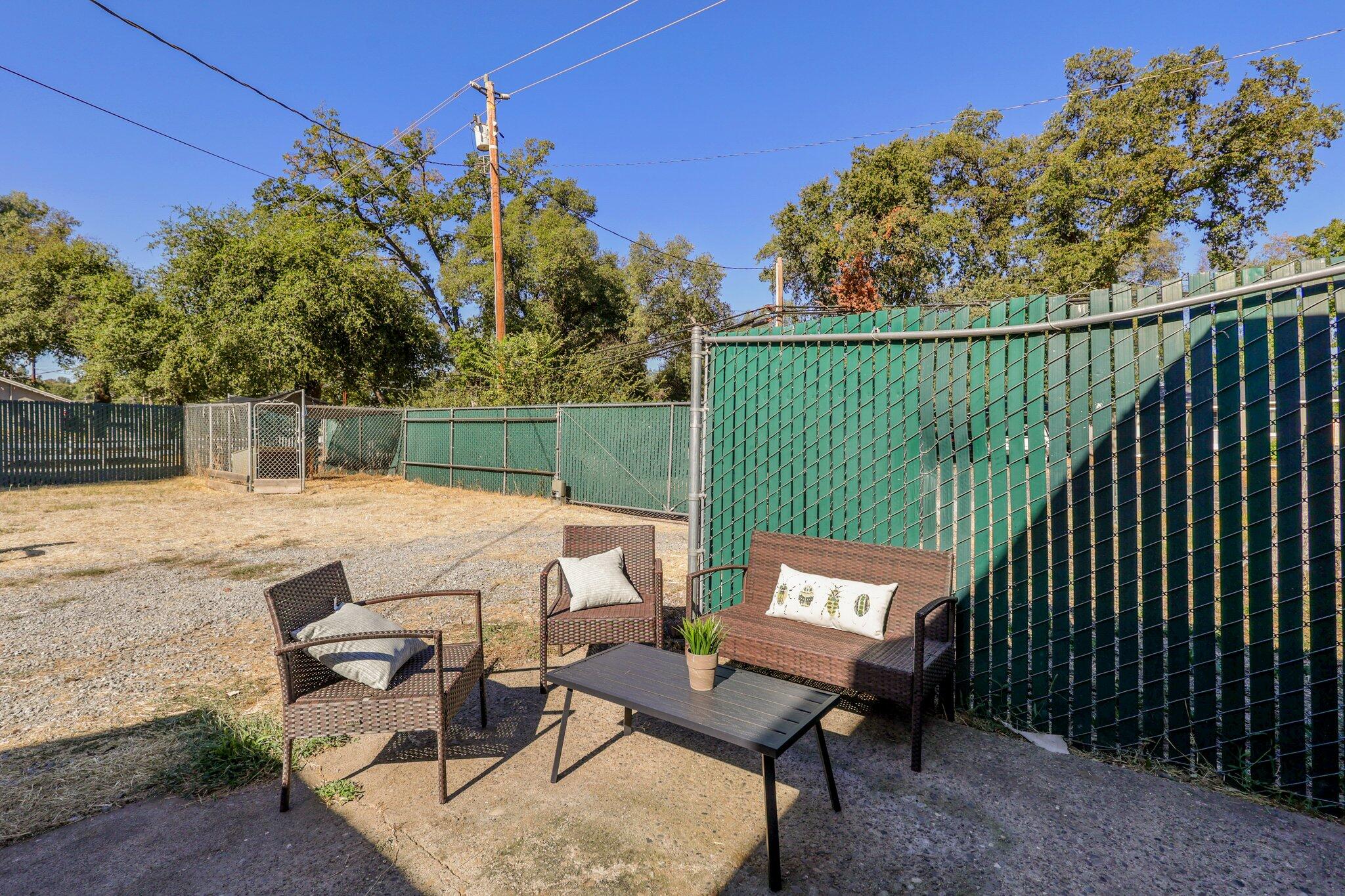 7699 Happy Valley Road Anderson, CA 96007 - Photo 12 of 49 a view of a patio with a table and chairs