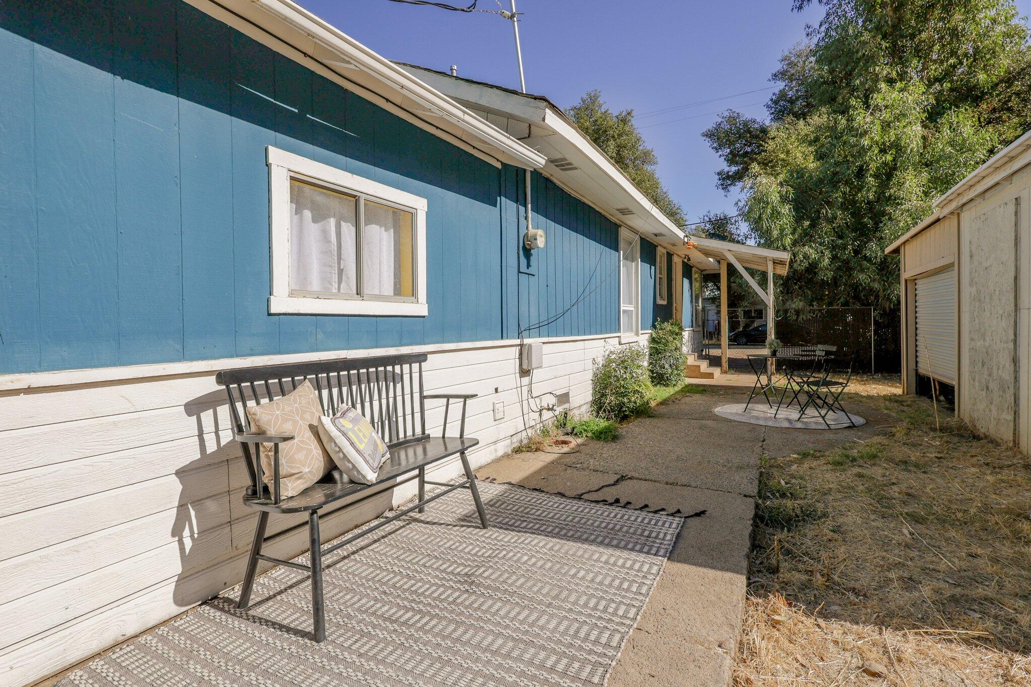 7699 Happy Valley Road Anderson, CA 96007 - Photo 13 of 49 a backyard of a house with table and chairs