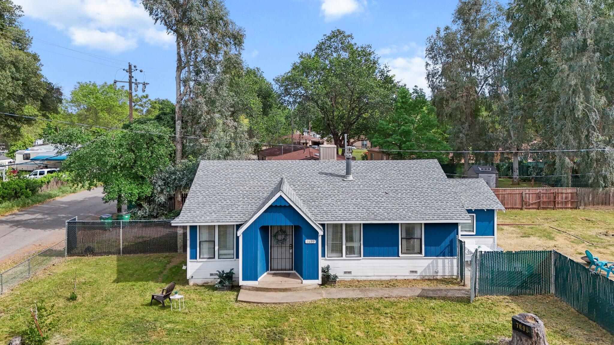 7699 Happy Valley Road Anderson, CA 96007 - Photo 2 of 49 a front view of a house with garden